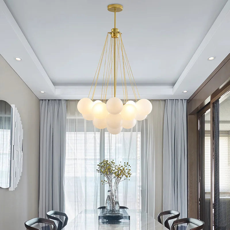 Modern metal chandelier with glass sphere and decorative bubbles